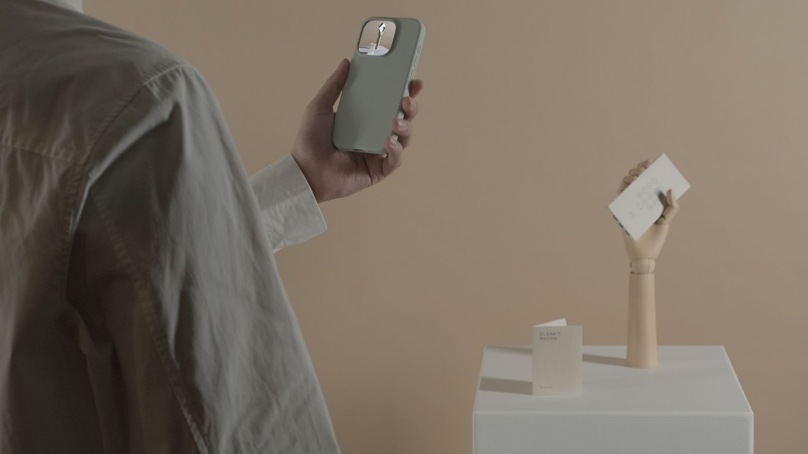 Image may contain Electronics Phone Mobile Phone Adult Person and Iphone