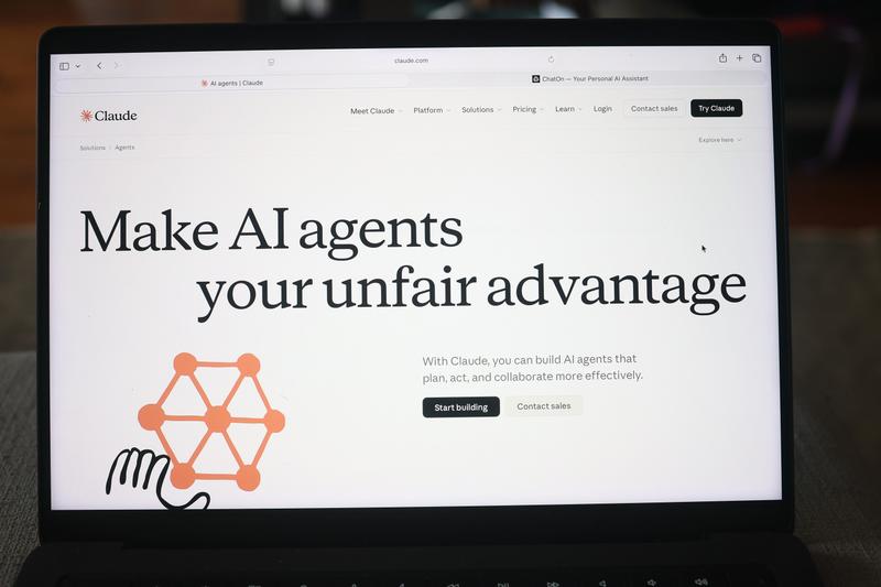 The Claude website is seen on a laptop