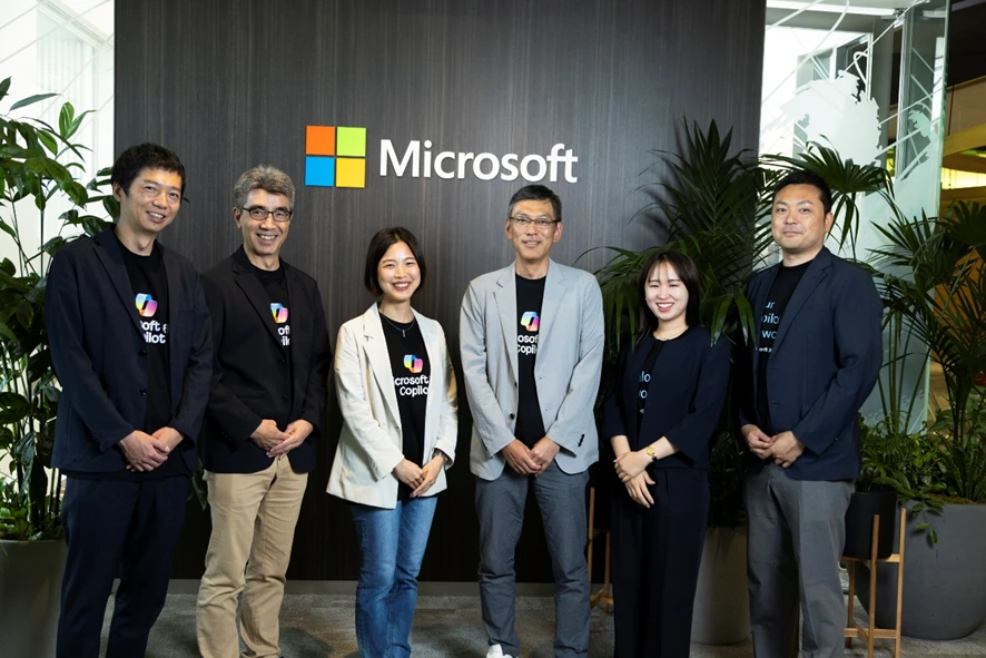 A group of people standing in front of a sign